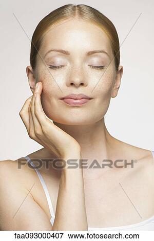 Young woman enjoying soft and smooth results of proper skin care View Large Photo Image Stock Photo - Young woman enjoying soft and smooth results of proper skin care. Fotosearch