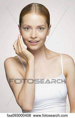 Young woman enjoying soft and smooth results of proper skin care View Large Photo Image Stock Photo - Young woman enjoying soft and smooth results of proper skin care. Fotosearch