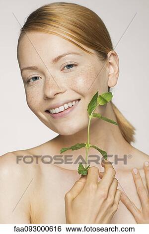 Young woman enjoying softness of fresh mint leaves View Large Photo Image Stock Photograph - Young woman enjoying softness of fresh mint leaves. Fotosearch