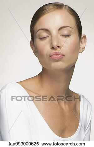 Young woman, eyes cloed, with pursed lips View Large Photo Image Stock Photography - Young woman, eyes cloed, with pursed lips. Fotosearch