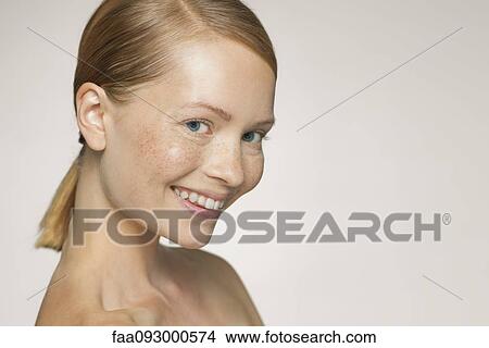 Picture - Young woman smiling coyly. Fotosearch