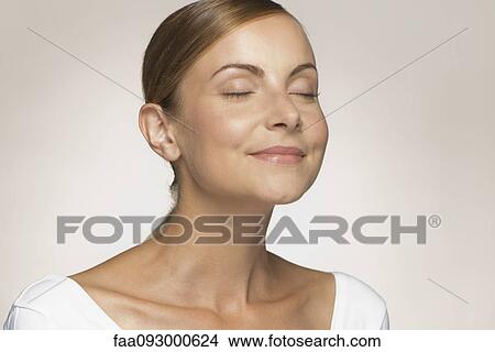 Young woman smiling with eyes closed View Large Photo Image Picture - Young woman smiling with eyes closed. Fotosearch