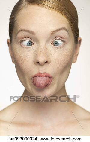 Picture - Young woman sticking out tongue. Fotosearch