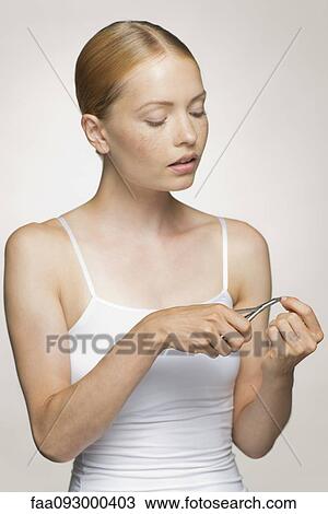 Young woman trimming cuticle View Large Photo Image Stock Image - Young woman trimming cuticle. Fotosearch
