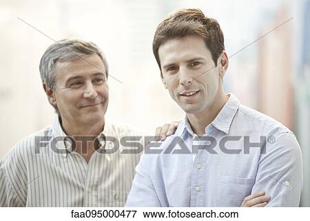 Stock Photo - Adult son and father, portrait. Fotosearch