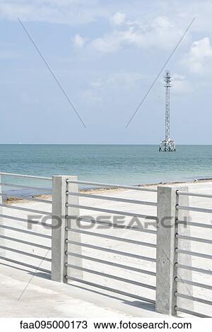Barrier on beach, telecommunications tower in background View Large Photo Image Stock Image - Barrier on beach, telecommunications tower in background. Fotosearch