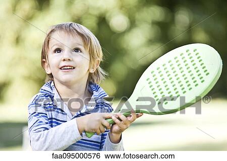 Stock Photograph - Boy holding racket. Fotosearch