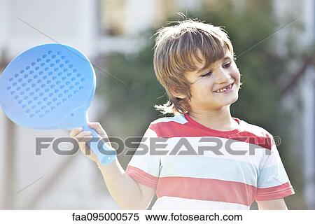 Stock Photography - Boy holding racket. Fotosearch