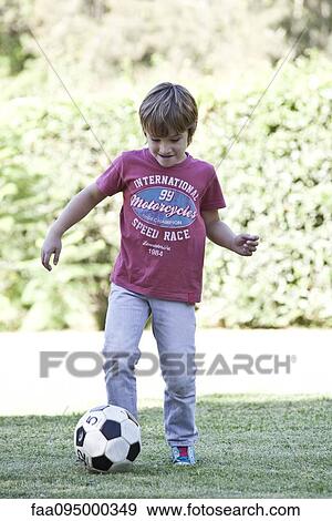 Boy kicking soccer View Large Photo Image Stock Photo - Boy kicking soccer. Fotosearch