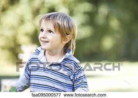 Stock Photo - Boy looking up. Fotosearch