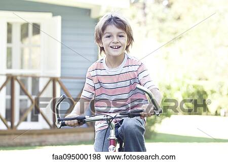 Stock Photo - Boy riding bicycle. Fotosearch
