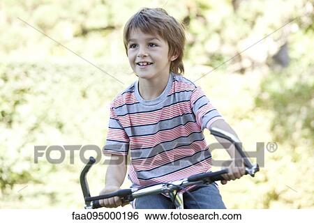 Boy riding bicycle View Large Photo Image Stock Photograph - Boy riding bicycle. Fotosearch