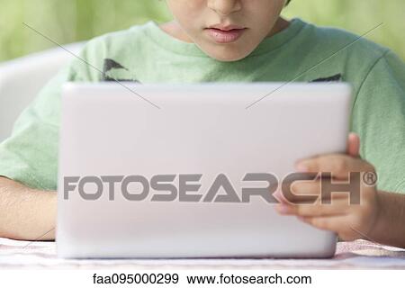 Boy using digital tablet View Large Photo Image Stock Photo - Boy using digital tablet. Fotosearch