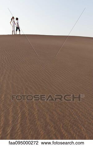 Brother and sister walking along top of dune View Large Photo Image Stock Image - Brother and sister walking along top of dune. Fotosearch
