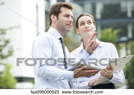 Business associates collaborating using digital tablet View Large Photo Image Stock Image - Business associates collaborating using digital tablet. Fotosearch