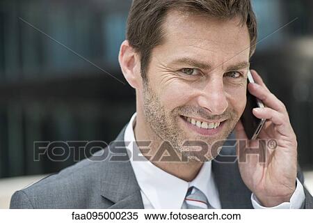 Stock Photography - Businessman making phone call. Fotosearch