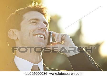 Businessman talking on cell phone, portrait View Large Photo Image Stock Photograph - Businessman talking on cell phone, portrait. Fotosearch