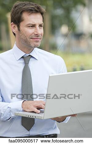 Businessman working outdoors View Large Photo Image Stock Photo - Businessman working outdoors. Fotosearch