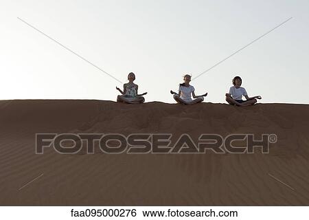 Children meditating on sand dune View Large Photo Image Stock Photograph - Children meditating on sand dune. Fotosearch