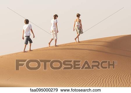 Stock Photo - Children walking in desert. Fotosearch