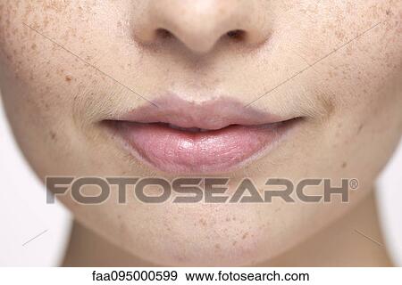 Close-up of young woman's face and lips View Large Photo Image Stock Photo - Close-up of young woman's face and lips. Fotosearch
