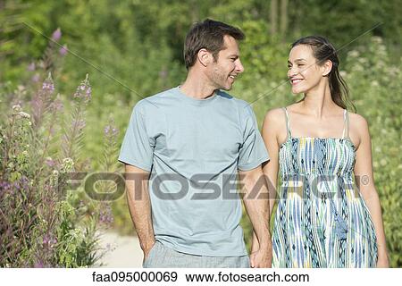 Stock Photo - Couple on walk in countryside. Fotosearch