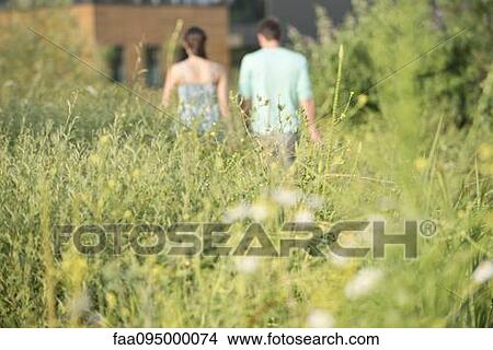 Couple together on walk, rear view View Large Photo Image Picture - Couple together on walk, rear view. Fotosearch