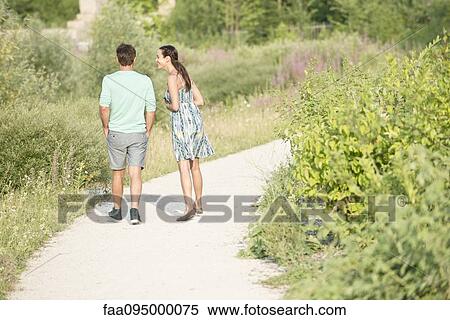 Couple together on walk through park View Large Photo Image Stock Photography - Couple together on walk through park. Fotosearch