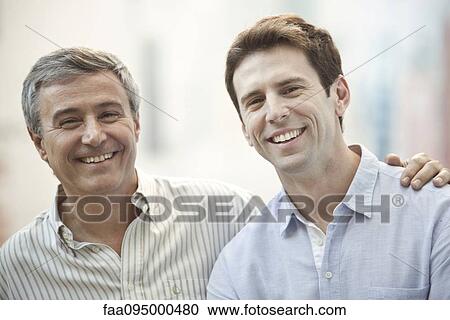 Stock Image - Father and adult son, portrait. Fotosearch