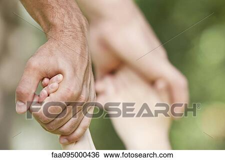 Father holding child's hands View Large Photo Image Stock Photograph - Father holding child's hands. Fotosearch
