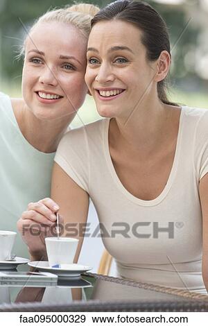 Friends having coffee together and gossipping View Large Photo Image Stock Photo - Friends having coffee together and gossipping. Fotosearch