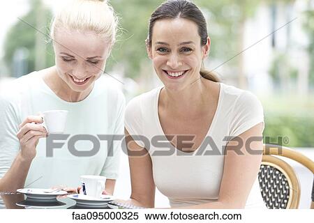 Friends having coffee together View Large Photo Image Stock Photography - Friends having coffee together. Fotosearch