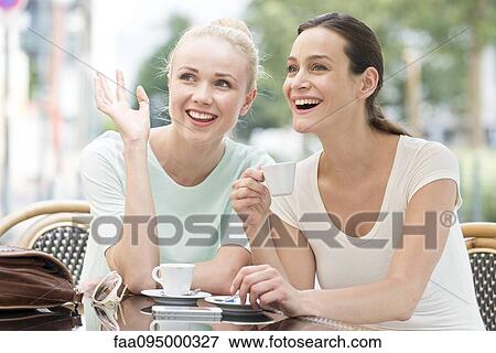 Stock Photo - Friends having laugh together. Fotosearch