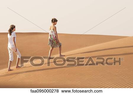 Girls walking in desert View Large Photo Image Stock Photo - Girls walking in desert. Fotosearch