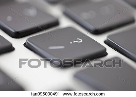 Stock Image - Laptop computer, focus on question mark key. Fotosearch