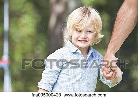 Stock Photo - Little boy holding father's hand. Fotosearch