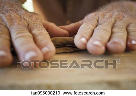Man's hands crafting a cigar View Large Photo Image Stock Image - Man's hands crafting a cigar. Fotosearch