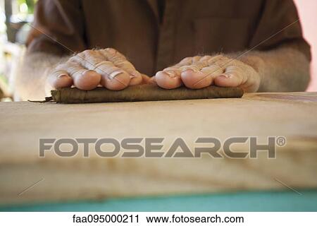 Man's hands crafting a cigar View Large Photo Image Stock Image - Man's hands crafting a cigar. Fotosearch