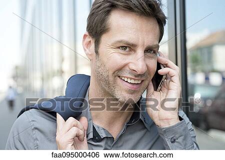 Mature man making phone call using smartphone View Large Photo Image Stock Photograph - Mature man making phone call using smartphone. Fotosearch