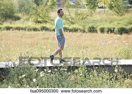 Stock Image - Mature man on countryside walk. Fotosearch