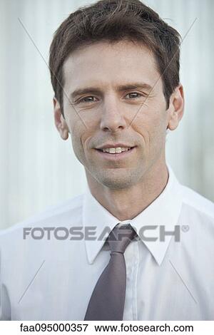 Stock Photo - Mid-adult businessman, portrait. Fotosearch