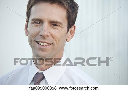 Stock Photo - Mid-adult businessman, portrait. Fotosearch