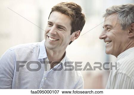 Stock Photo - Mid-adult man with friend. Fotosearch