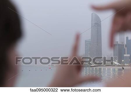 Person looking through finger frame at coastal skyscraper View Large Photo Image Stock Image - Person looking through finger frame at coastal skyscraper. Fotosearch