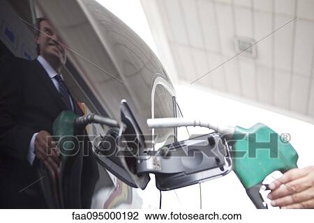 Stock Image - Refueling car at gas station. Fotosearch