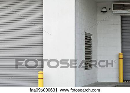 Stock Image - Rolling garage door of loading dock. Fotosearch