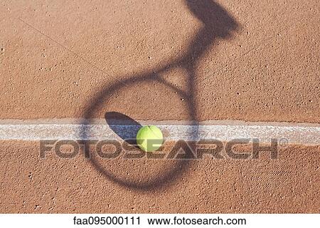 Shadow of tennis racket over tennis ball View Large Photo Image Stock Image - Shadow of tennis racket over tennis ball. Fotosearch