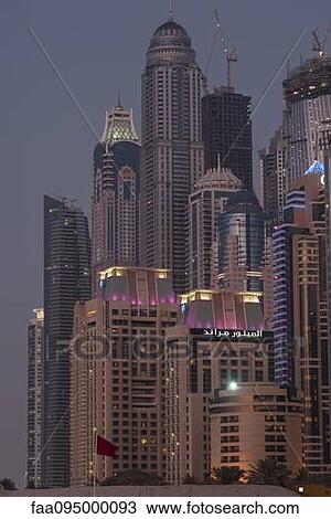 Skyscrapers illuminated at twilight, Dubai, United Arab Emirates View Large Photo Image Stock Image - Skyscrapers illuminated at twilight, Dubai, United Arab Emirates. Fotosearch