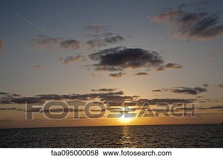 Sun setting over sea View Large Photo Image Stock Photo - Sun setting over sea. Fotosearch