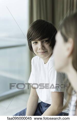 Stock Photography - Teenage boy smiling at girl. Fotosearch